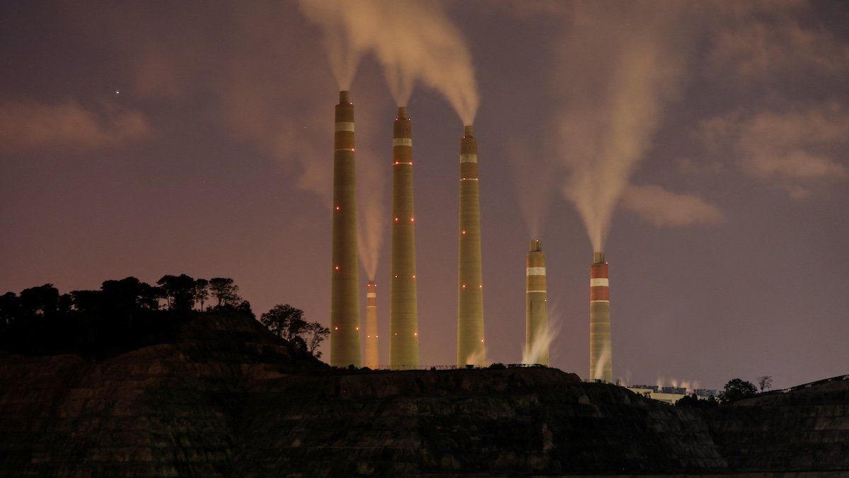 FILE PHOTO: Smoke and steam billows from the coal-fired power plant owned by Indonesia Power, next to an area for Java 9 and 10 Coal-Fired Steam Power Plant Project in Suralaya, Banten province, Indonesia, July 11, 2020. 