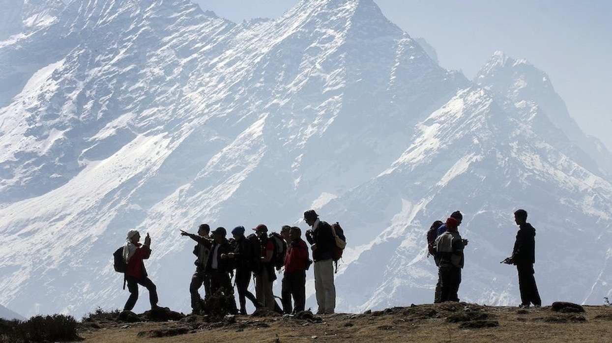 FILE PHOTO: Trekkers pause to admire Mt. Kusum Kangru (6369 mts) in the Mt. Everest region in Nepal March 30, 2006.