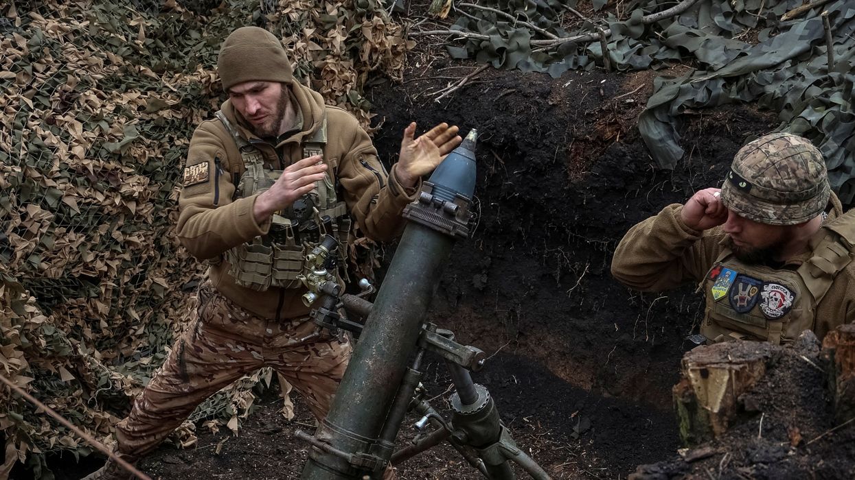 FILE PHOTO: Ukrainian servicemen of the 28th Separate Mechanized Brigade fire a 120-mm mortar towards Russian troops at a frontline, amid Russia's attack on Ukraine, near the town of Bakhmut, Ukraine March 15, 2024.