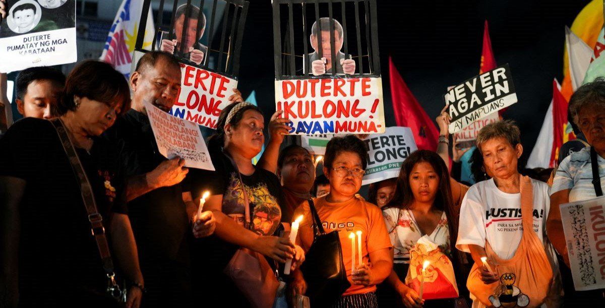 ​Filipino activists hold candles during a protest vigil supporting former President Rodrigo Duterte's arrest warrant by the International Criminal Court, in Quezon City, Metro Manila, Philippines, March 11, 2025. 