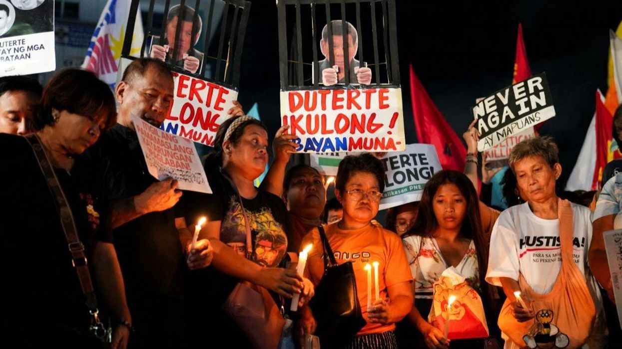 Filipino activists hold candles during a protest vigil supporting former President Rodrigo Duterte's arrest warrant by the International Criminal Court, in Quezon City, Metro Manila, Philippines, March 11, 2025.