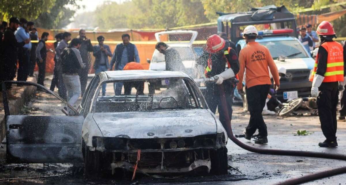 ​Firefighter douses a vehicle after a blast outside a court building in Islamabad, Pakistan November 11, 2025. 
