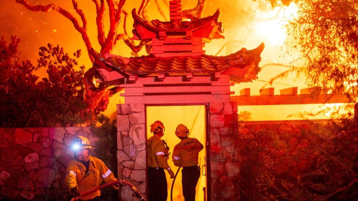 Firefighters battle the Palisades Fire as it burns during a windstorm on the west side of Los Angeles, California, on Jan. 8, 2025.