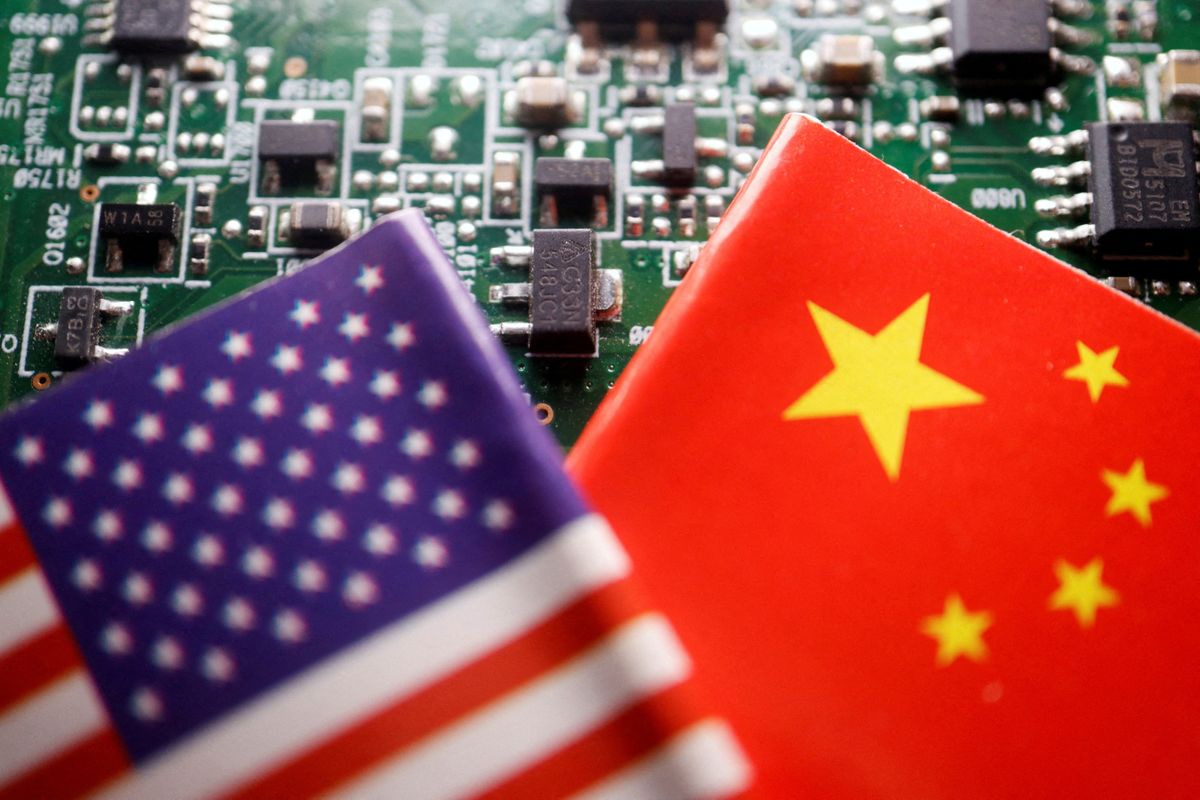 Flags of China and U.S. are displayed on a printed circuit board with semiconductor chips.