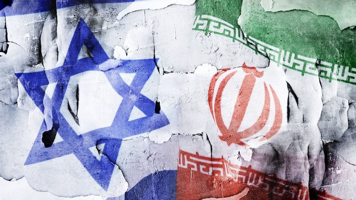 Flags of Israel and Iran on broken ground.