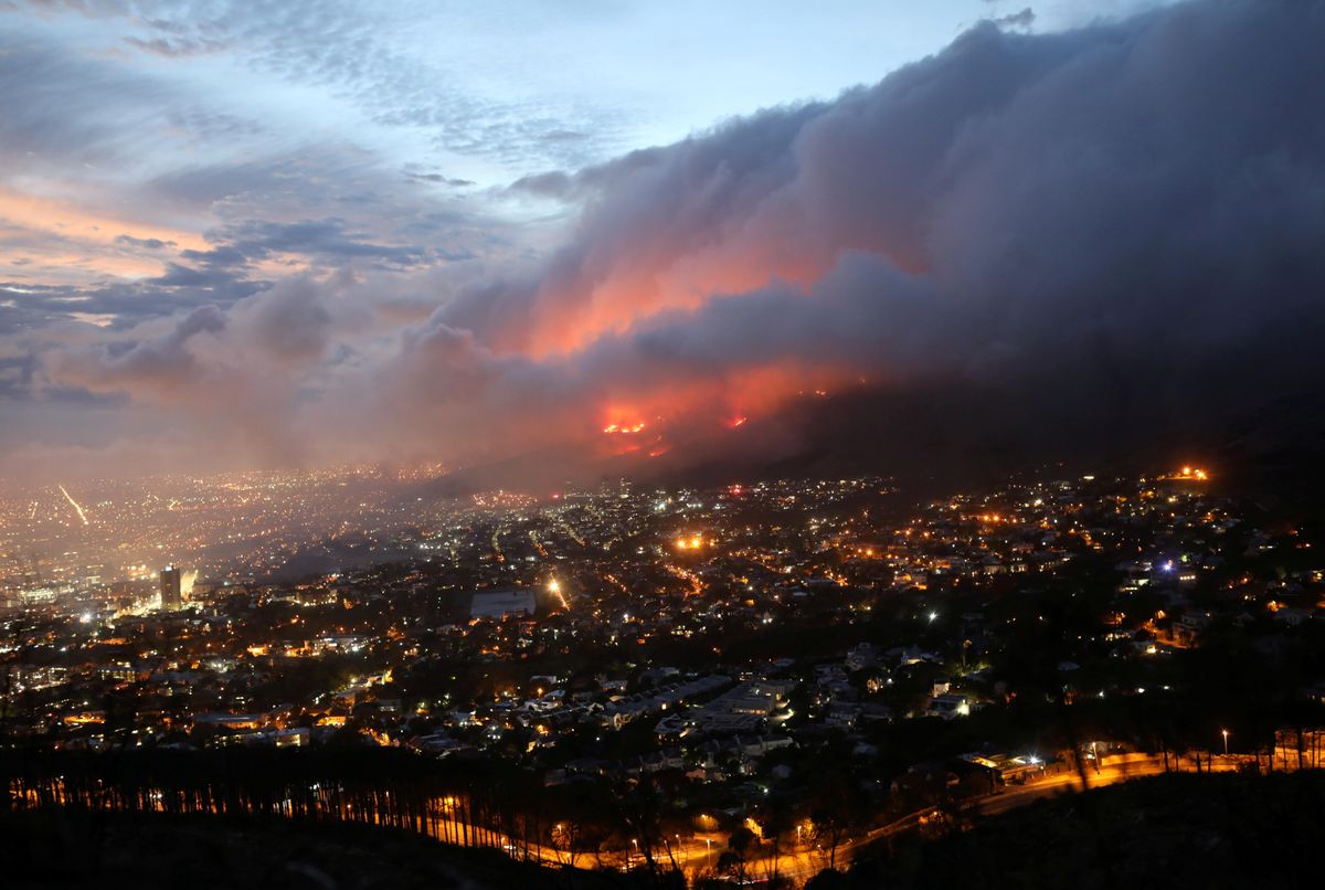 Flames are seen close to the city fanned by strong winds after a bushfire broke out on the slopes of Table Mountain in Cape Town, South Africa, April 19, 2021.
