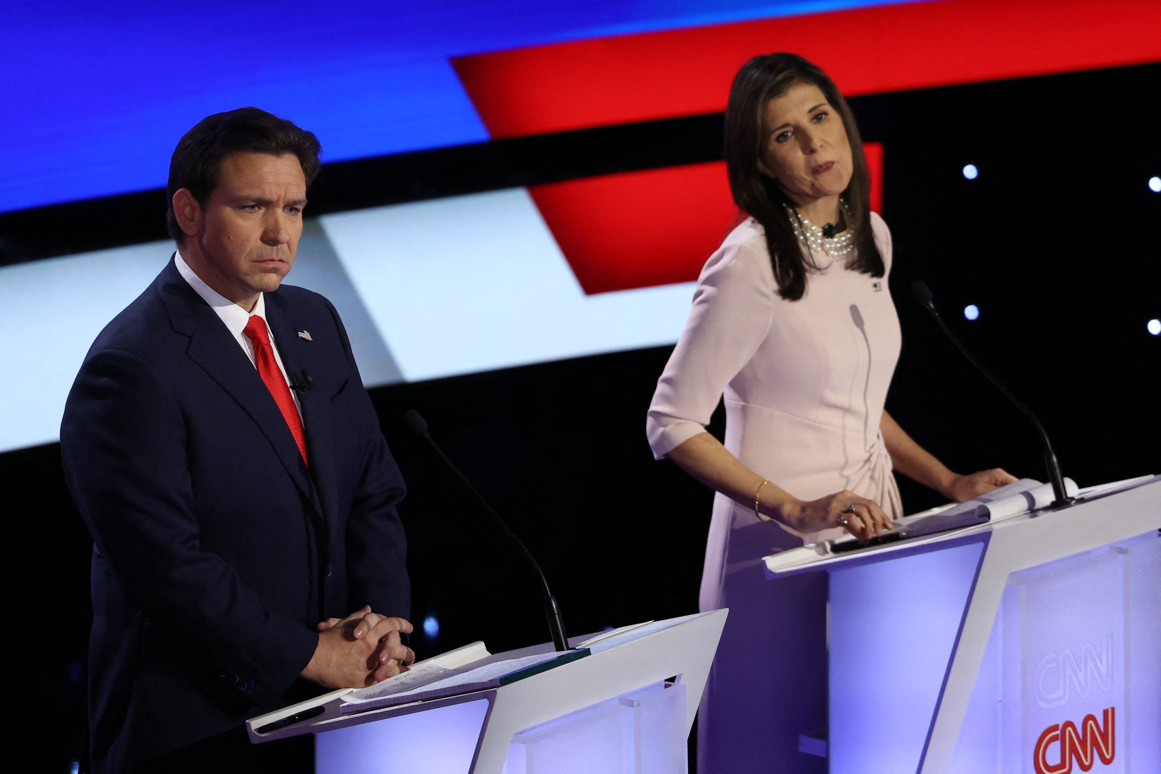 ​Florida Gov. Ron DeSantis and fomrer US Ambassador to the United Nations Nikki Haley listen to a question as they participate in the Republican presidential debate hosted by CNN at Drake University in Des Moines, Iowa. 