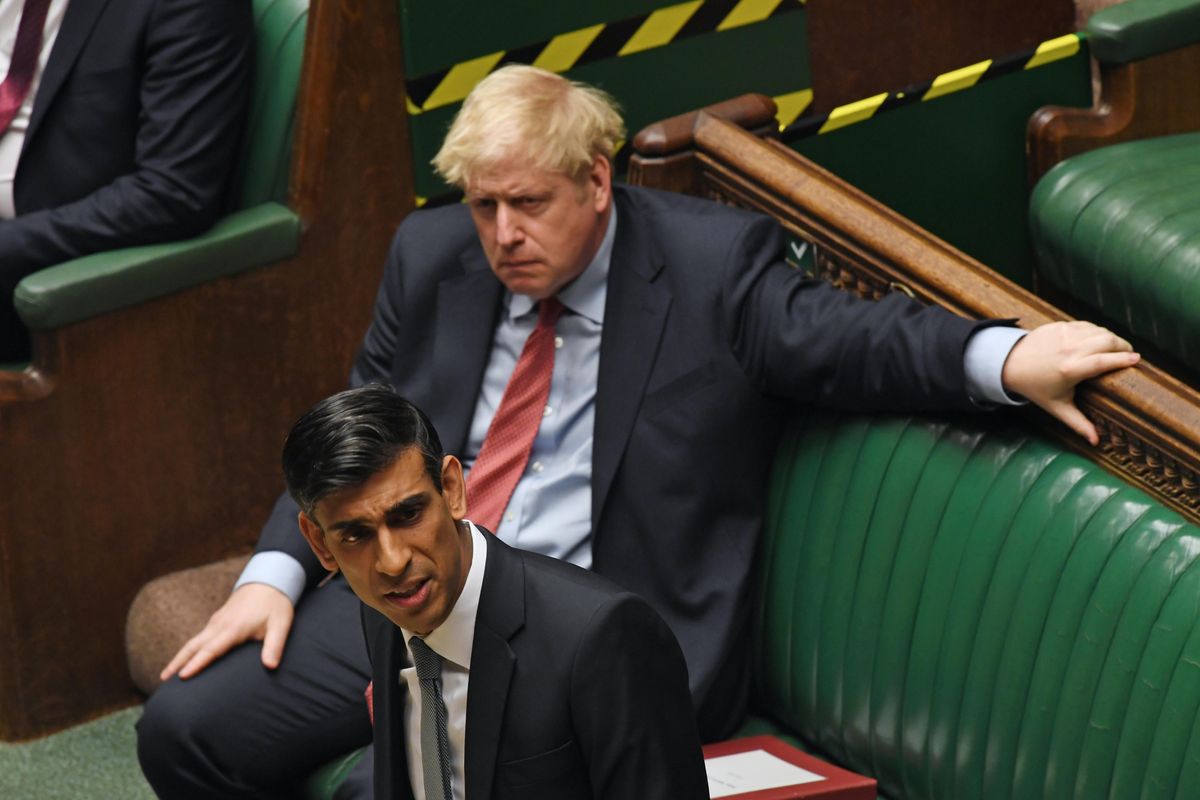 Former British PM Boris Johnson looks on as then-Chancellor of the Exchequer Rishi Sunak speaks at the House of Commons in 2020.