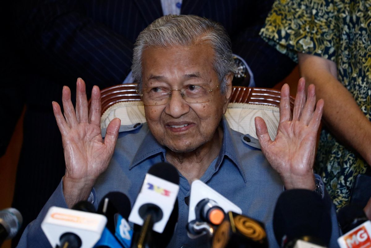 Former Malaysian PM Mahathir Mohamad gestures during a news conference in Putrajaya.