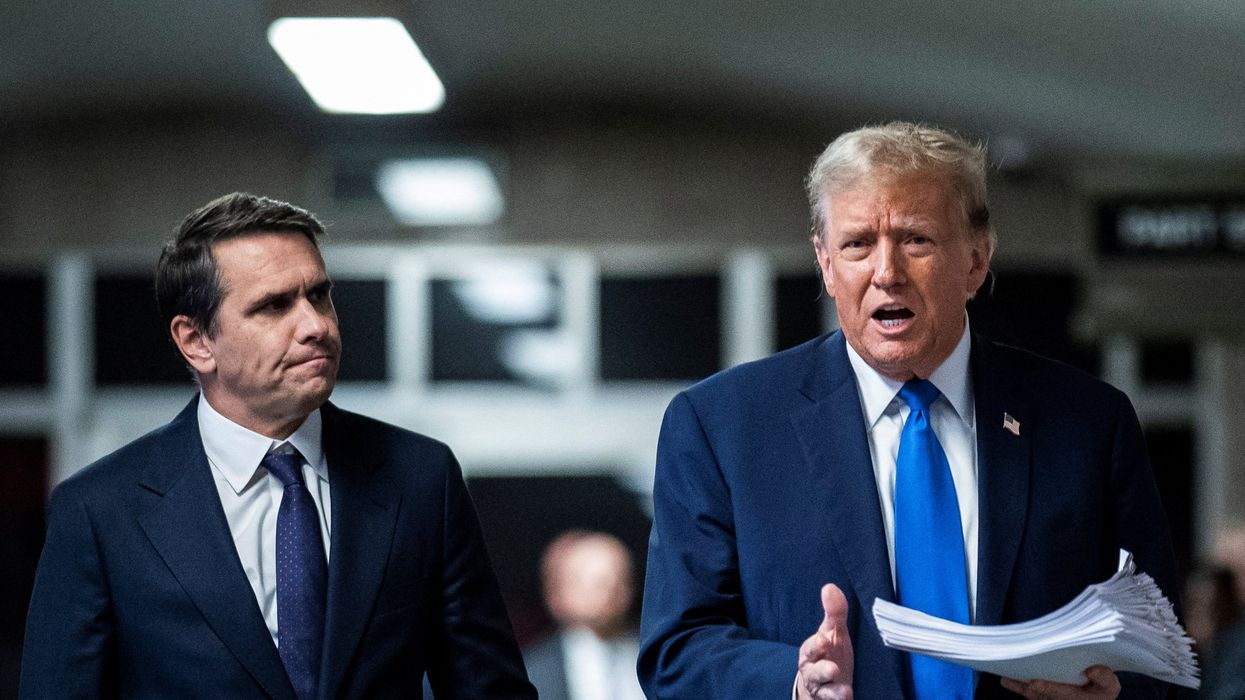 Former President Donald Trump speaks to reporters with attorney Todd Blanche at the end of the day at Manhattan criminal court as jury selection continues in New York, U.S., April 18, 2024.