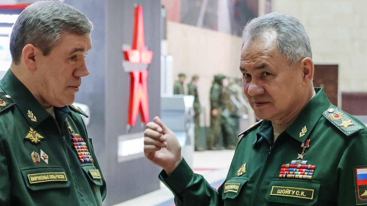 Former Russian Defence Minister Sergei Shoigu and Chief of the General Staff of Russian Armed Forces Valery Gerasimov talk in December 2023. Both men now face ICC warrants for alleged war crimes.
