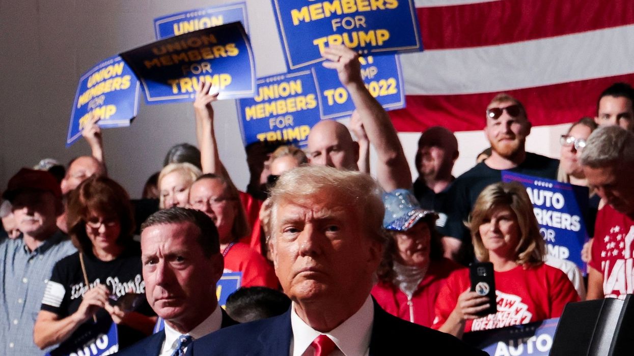 Former U.S. President and Republican presidential candidate Donald Trump looks on while his supporters cheer on the day he addresses auto workers as he skips the second GOP debate, in Clinton Township, Michigan, U.S., September 27, 2023.