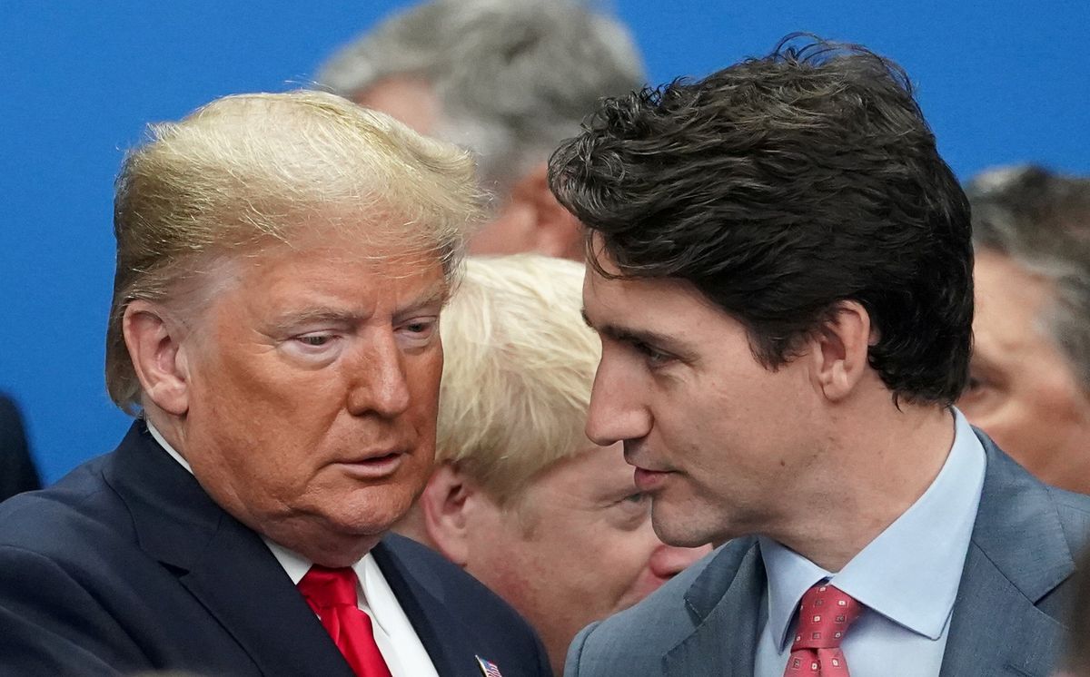 Former U.S. President Donald Trump talks with Canada's Prime Minister Justin Trudeau during a North Atlantic Treaty Organization