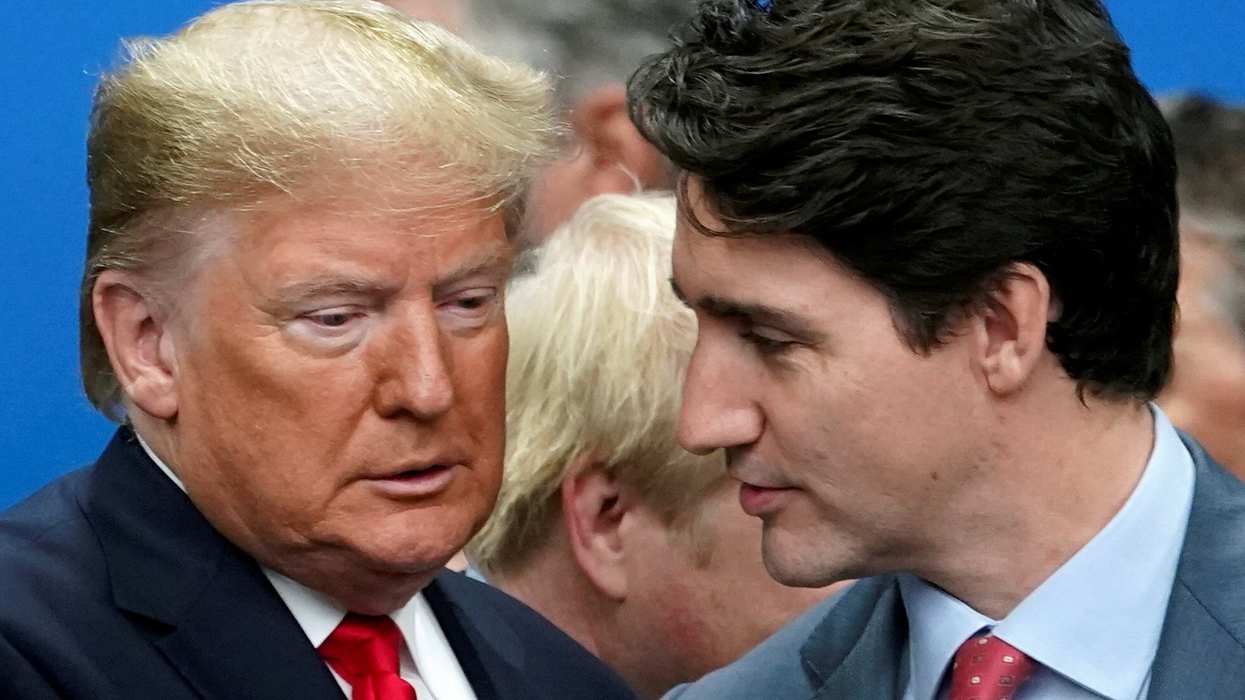 Former US President Donald Trump talks with Canada's Prime Minister Justin Trudeau.