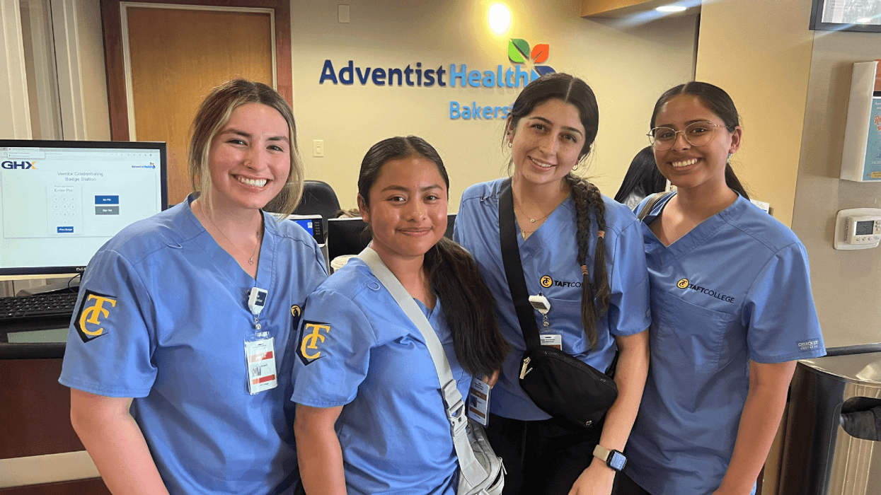 Four interns standing in a hospital lobby
