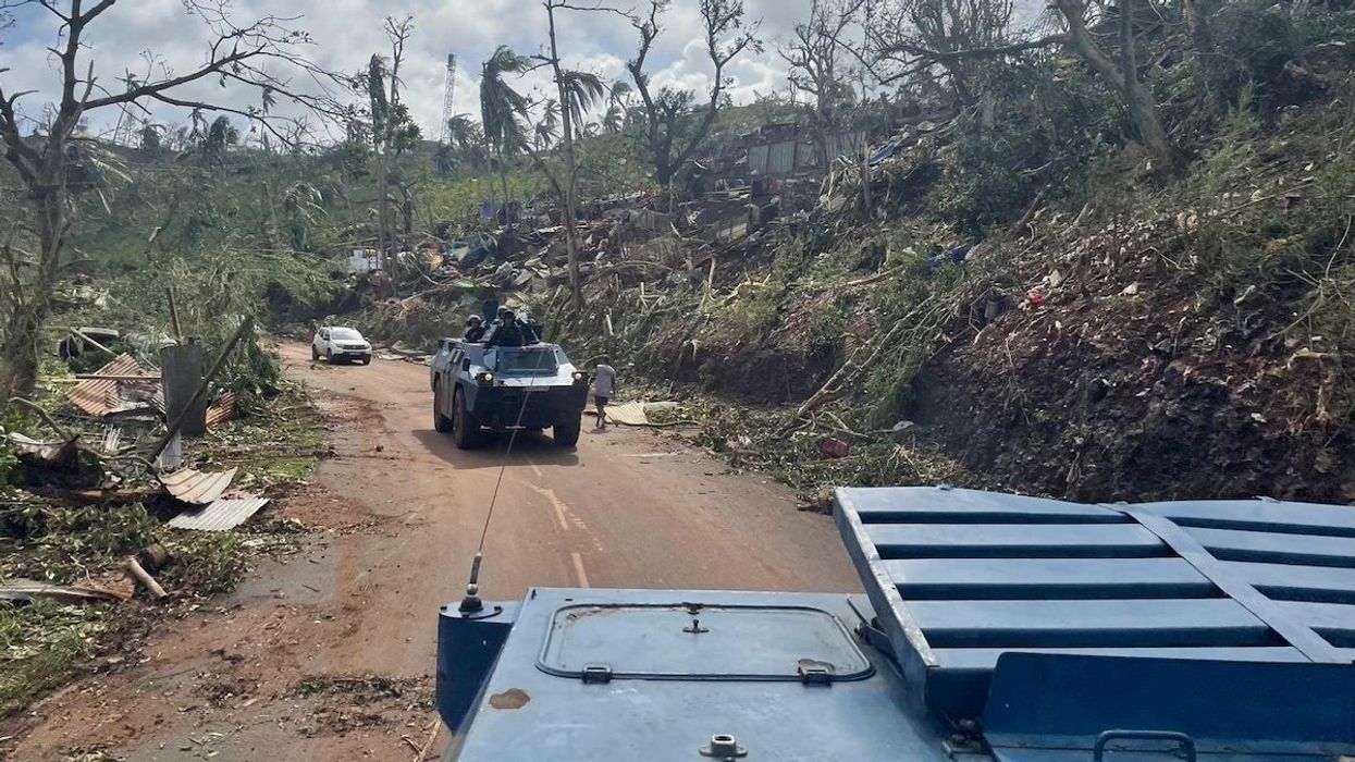 French Gendarmerie forces cross a damaged area in the aftermath of Cyclone Chido, in Mayotte, France December 15, 2024.
