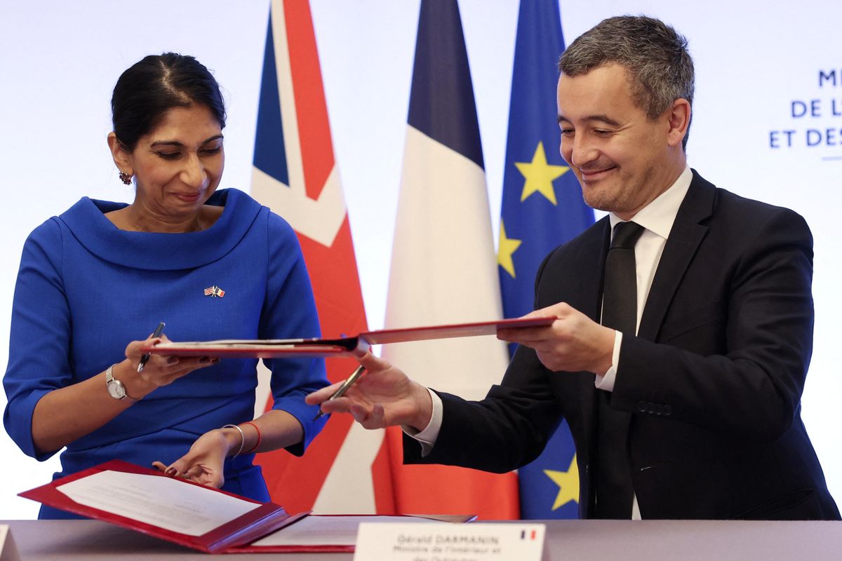 French Interior Minister Gerald Darmanin and UK Home Secretary Suella Braverman sign a joint declaration on migrants in Paris.