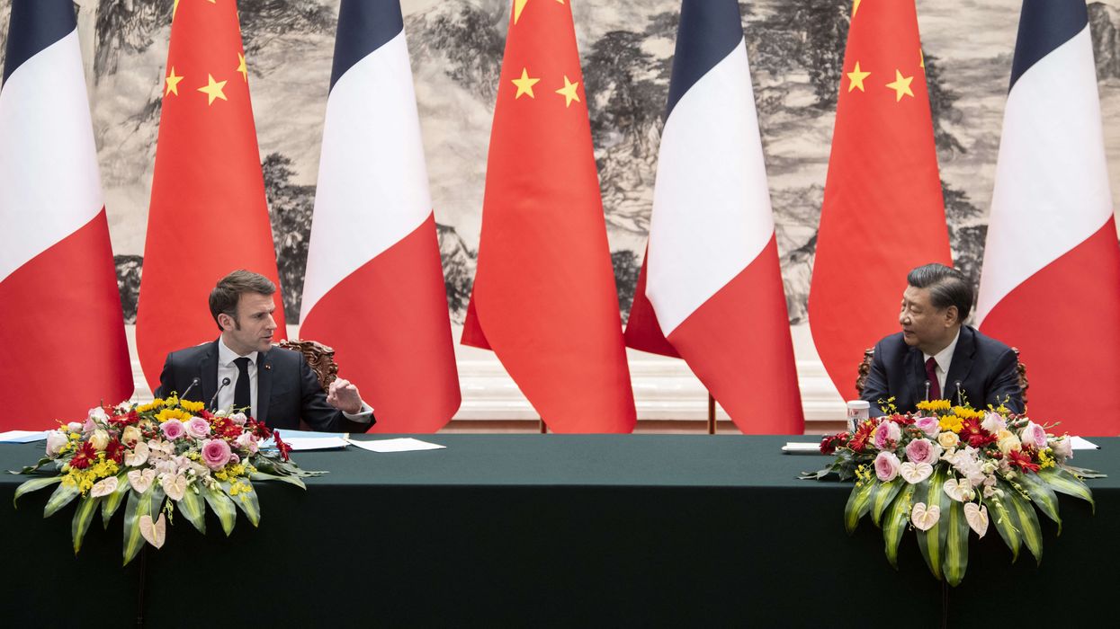 French President Emmanuel Macron and China’s President Xi Jinping gesture during a press conference in Beijing.