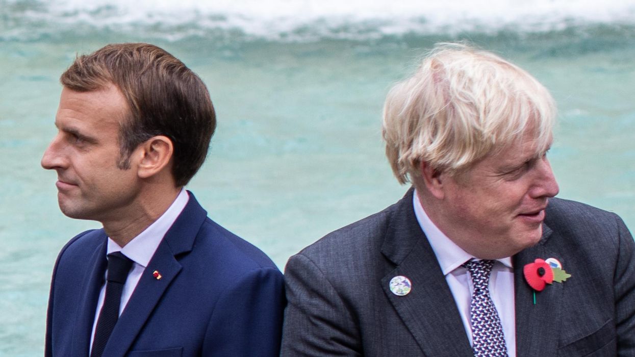 French President Emmanuel Macron (L) and UK Prime Minister Boris Johnson, among others, visit Rome's Trevi Fountain on the sidelines of the G20 World Leaders Summit.