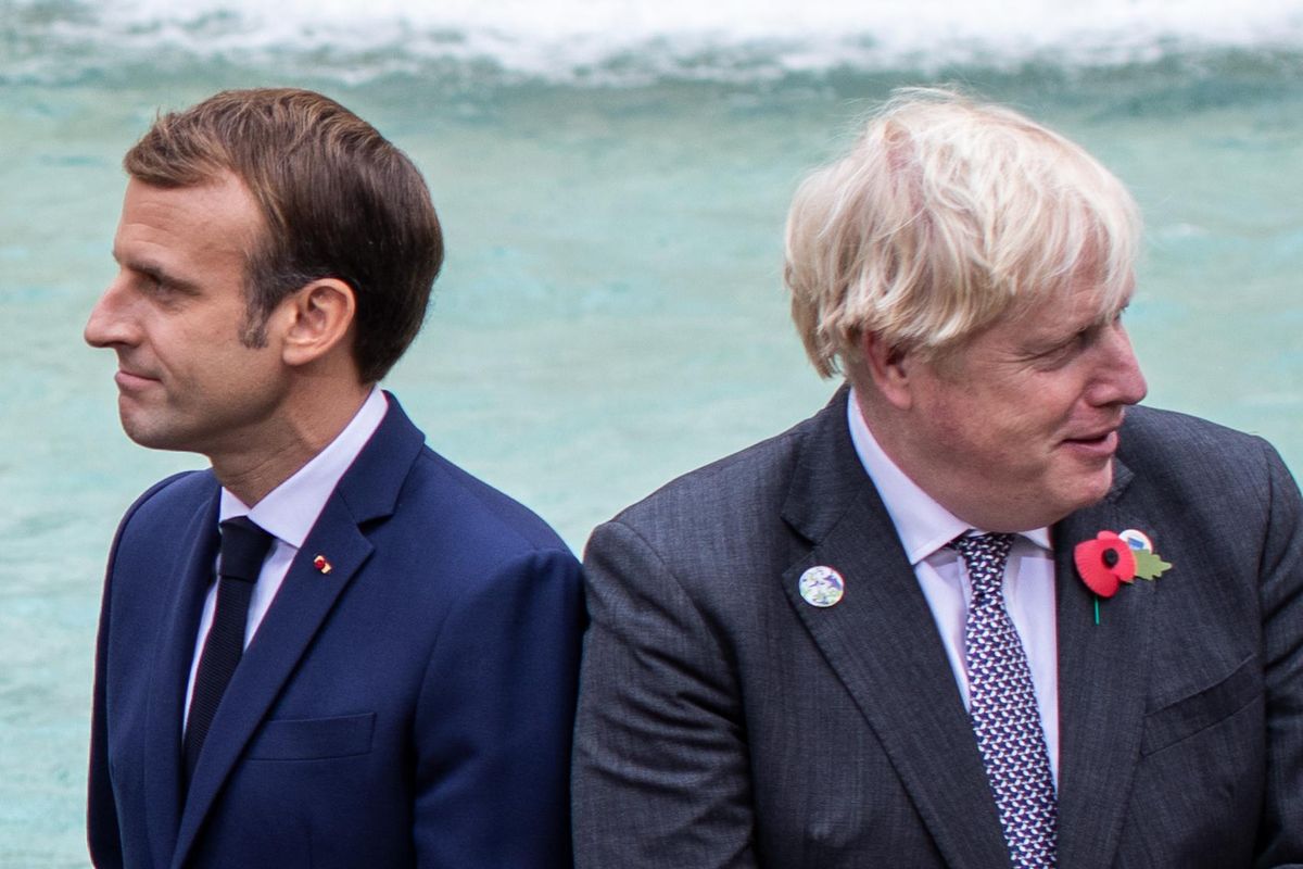 French President Emmanuel Macron (L) and UK Prime Minister Boris Johnson, among others, visit Rome's Trevi Fountain on the sidelines of the G20 World Leaders Summit.