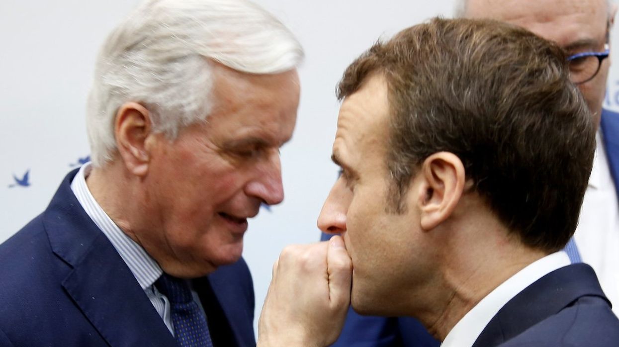 French President Emmanuel Macron speaks with then-EU Chief Brexit Negotiator Michel Barnier in February 2019.