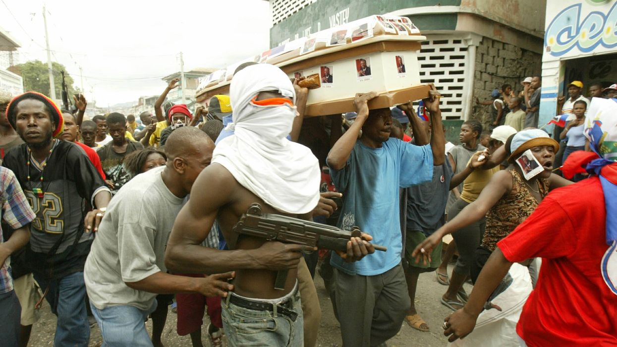 Gang member in carrying gun in Haiti