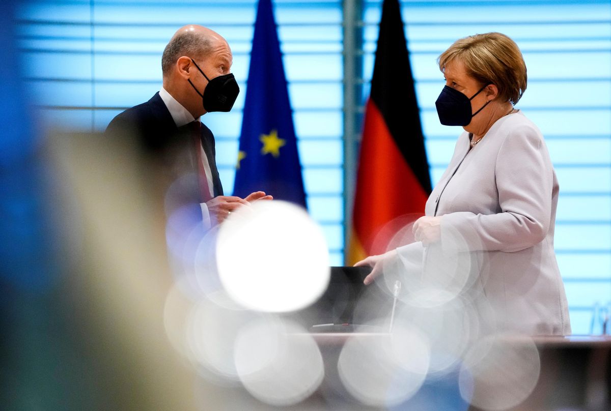 German Chancellor Angela Merkel speaks with Finance Minister Olaf Scholz at the weekly cabinet meeting in Berlin, Germany June 9, 2021. 