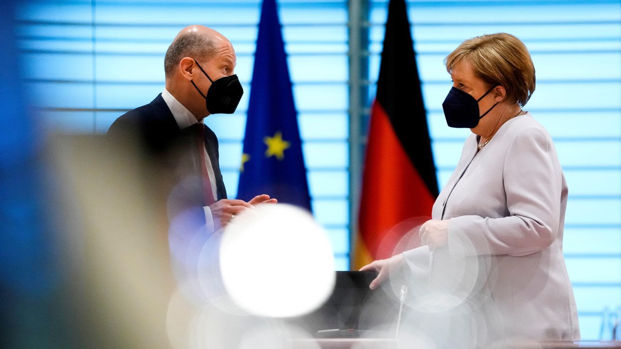 German Chancellor Angela Merkel speaks with Finance Minister Olaf Scholz at the weekly cabinet meeting in Berlin, Germany June 9, 2021.