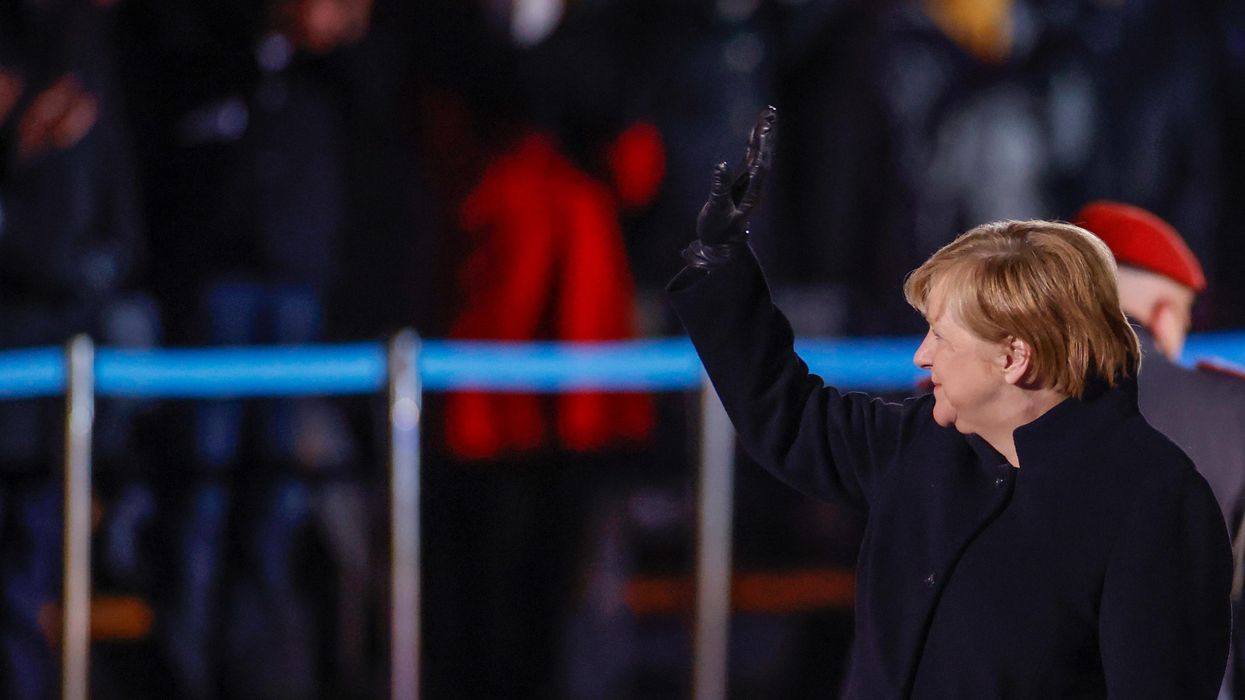 German Chancellor Angela Merkel waves goodbye at the defence ministry during the Grand Tattoo (Grosser Zapfenstreich), a ceremonial send-off for her in Berlin, Germany December 2, 2021.