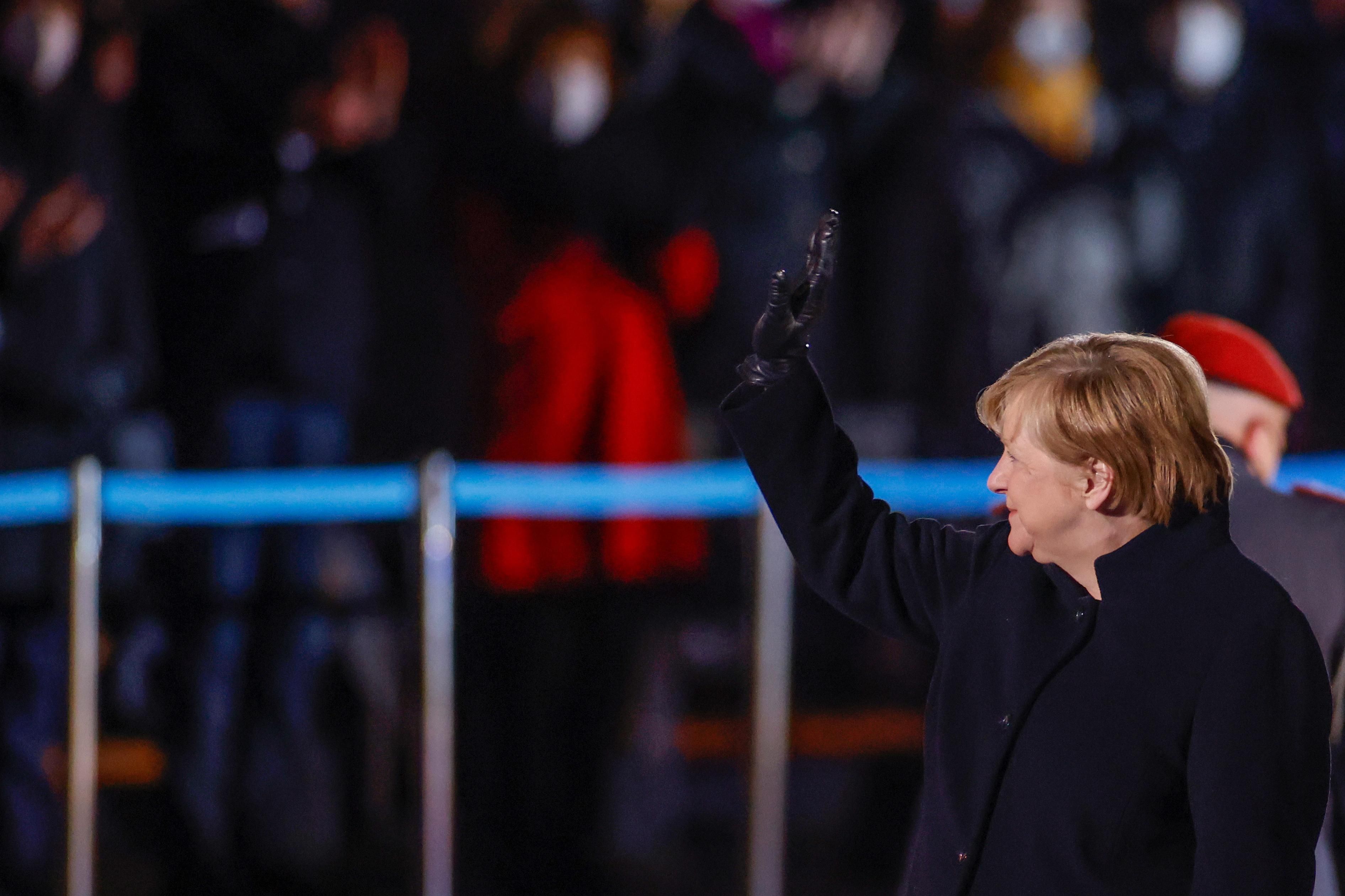 German Chancellor Angela Merkel waves goodbye at the defence ministry during the Grand Tattoo (Grosser Zapfenstreich), a ceremonial send-off for her in Berlin, Germany December 2, 2021.