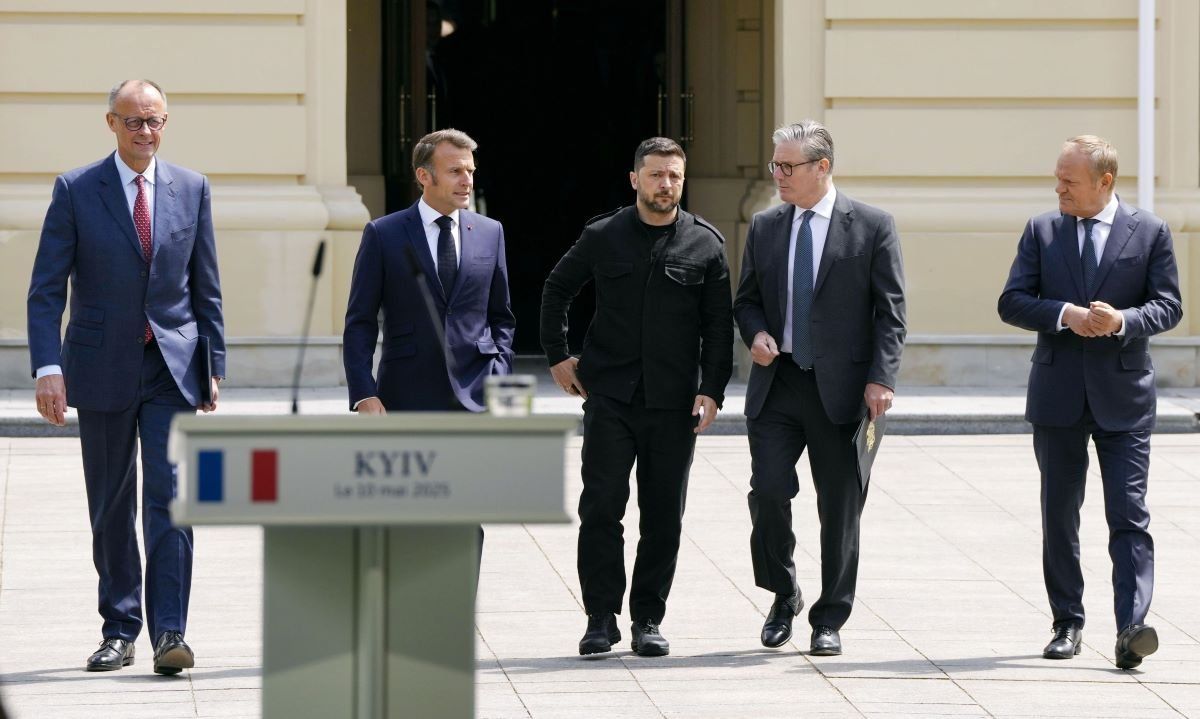 German Chancellor Friedrich Merz, French President Emmanuel Macron, Ukrainian President Volodymyr Zelenskyy, British Prime Minister Keir Starmer and Poland's Prime Minister Donald Tusk walk to the podium at the Presidential Palace in Kyiv, Ukraine, for a press conference after their meeting on May 10, 2025. 
