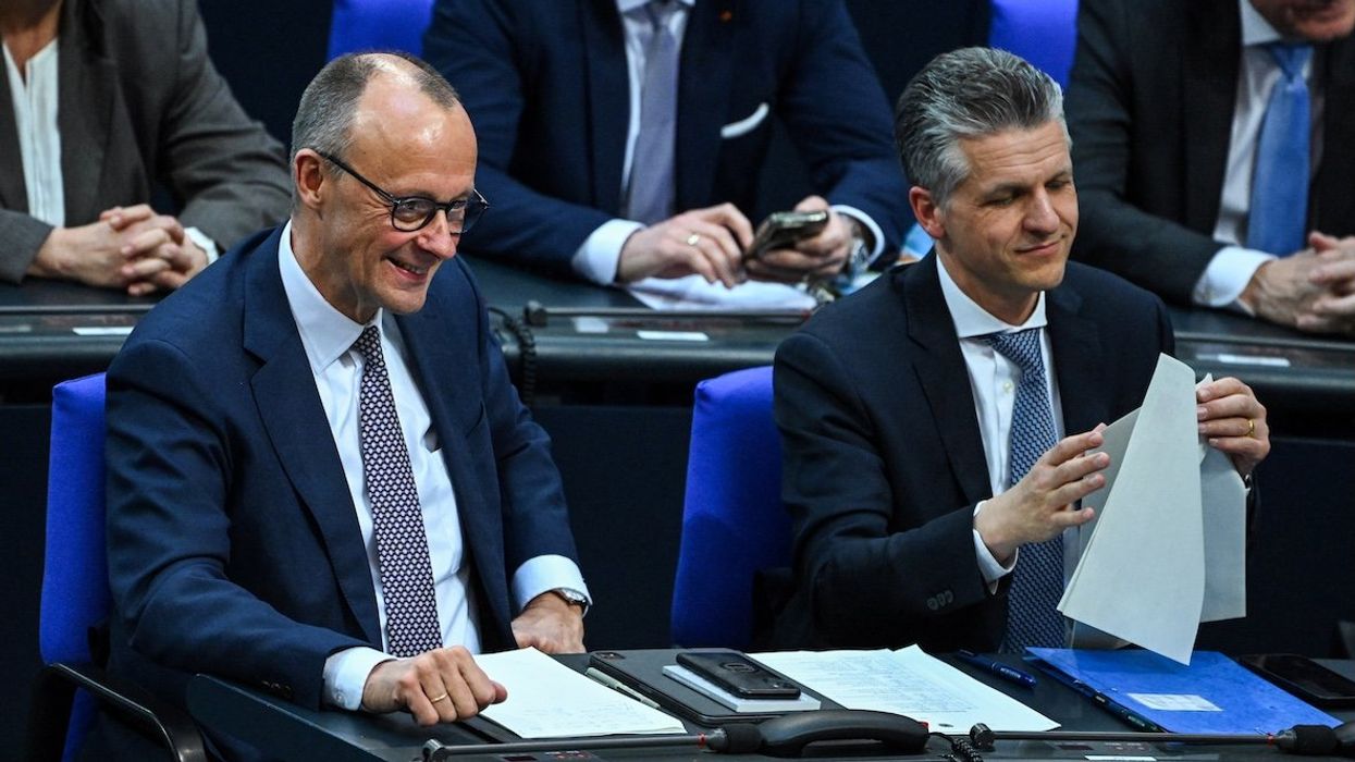 Germany's chancellor-in-waiting and leader of the Christian Democratic Union party Friedrich Merz reacts as he attends an extraordinary session of the outgoing lower house of parliament, the Bundestag, on March 18, 2025.