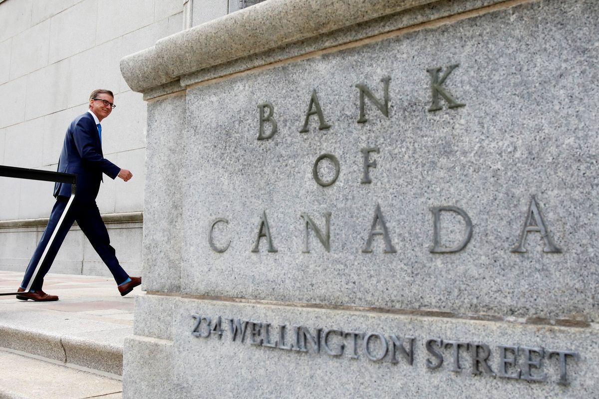 Gov. Tiff Macklem walks outside Bank of Canada building in Ottawa.