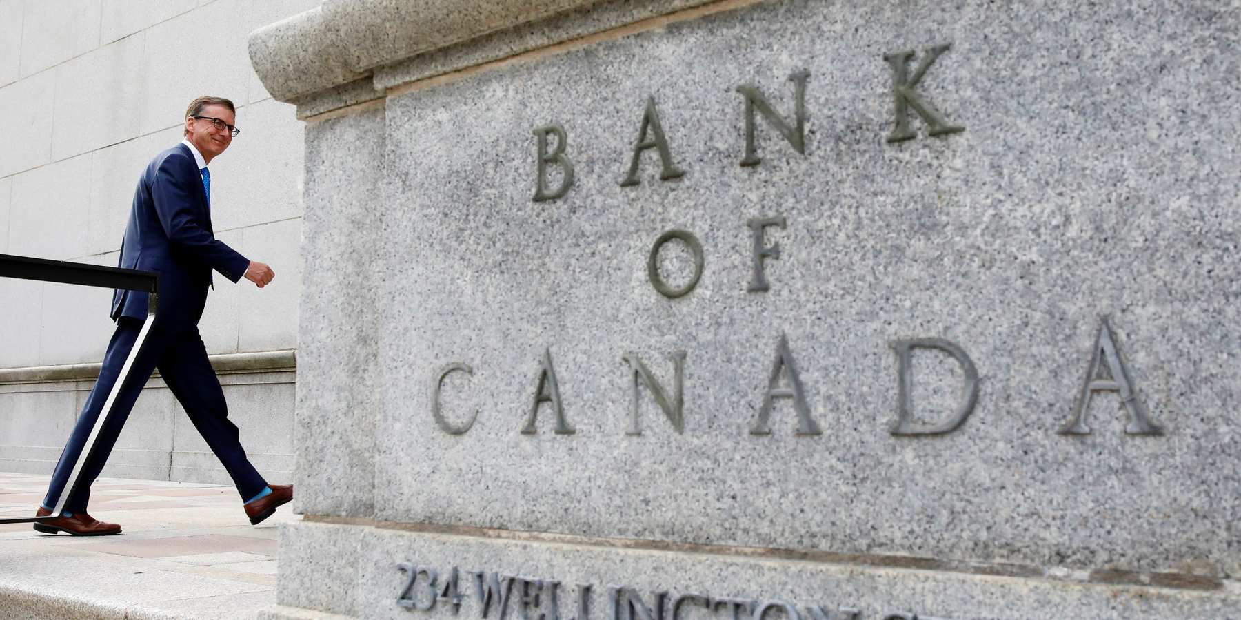 Governor of the Bank of Canada Tiff Macklem walks outside the Bank of Canada building in Ottawa, Ontario.