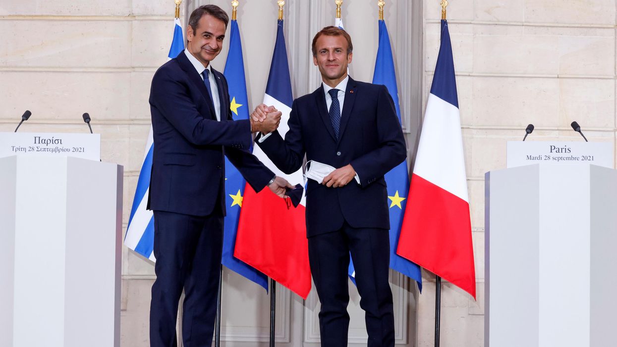 Greek Prime Minister Kyriakos Mitsotakis speaks as French President Emmanuel Macron listens on during a signing ceremony of a new defence deal at The Elysee Palace in Paris, France September 28, 2021.