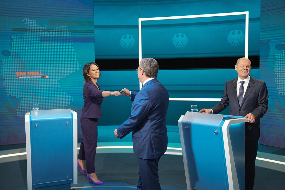 hairwoman of Buendnis 90/Die Gruenen Annalena Baerbock is greeted by Prime Minister of North Rhine-Westphalia (NRW) and leader of the Christian Democratic Union (CDU) Armin Laschet as German Finance Minister and Social Democratic Party candidate Olaf Scholz looks on before the start of a televised debate of the candidates to succeed Angela Merkel as German chancellor in Berlin, Germany, August 29, 2021