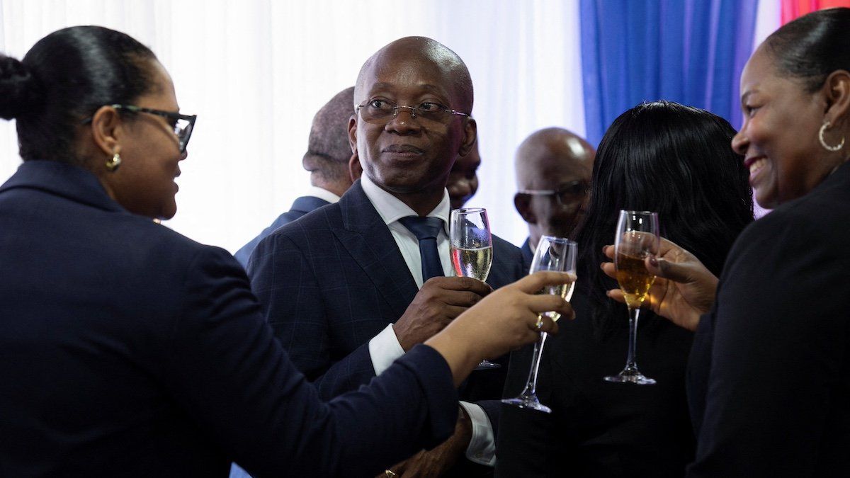​Haiti's new interim Prime Minister Michel Patrick Boisvert holds a glass with a drink after a transitional council took power with the aim of returning stability to the country, where gang violence has caused chaos and misery, on the outskirts of Port-au-Prince, Haiti April 25, 2024. 