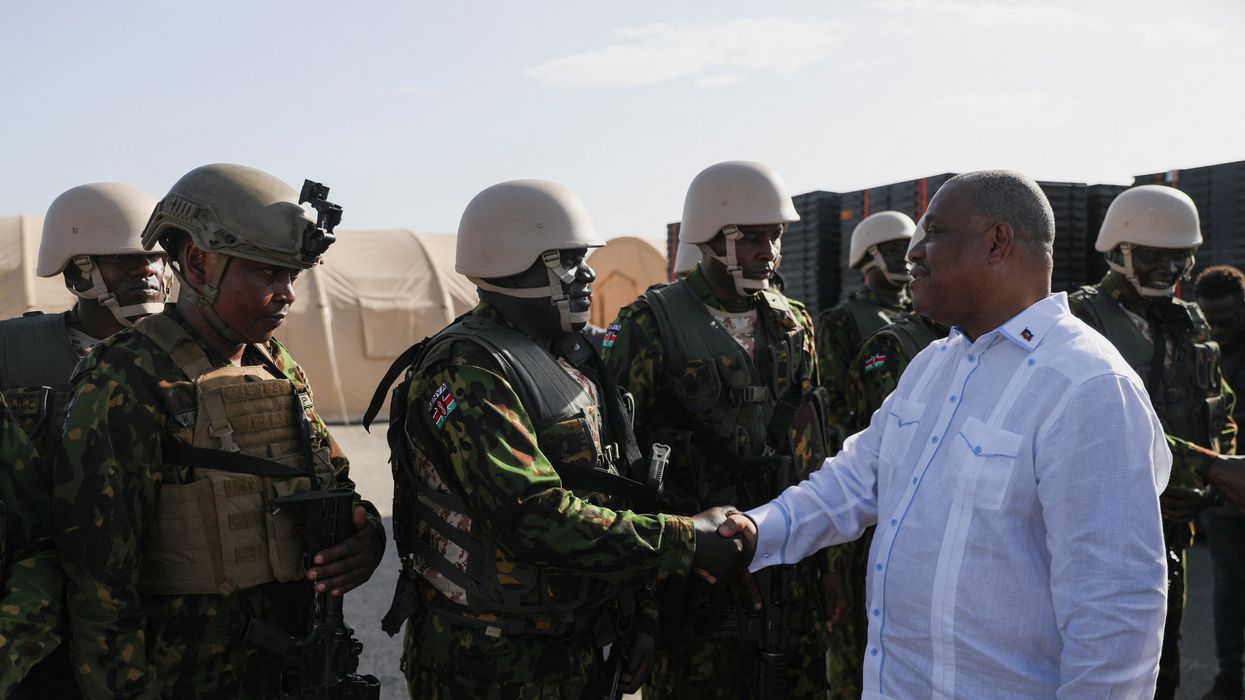 Haiti's Prime Minister Garry Conille shakes hands with members of the first contingent of Kenyan police as part of a peacekeeping mission in the Caribbean country, in Port-au-Prince, Haiti June 26, 2024.