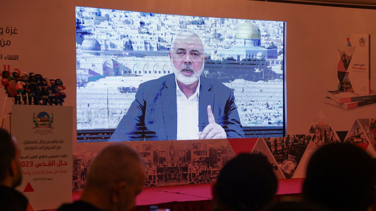 Hamas leader, Ismail Haniyeh, speaks in a pre-recorded message shown on a screen during a press event for Al Quds International Institution in Beirut, Lebanon February 28, 2024.