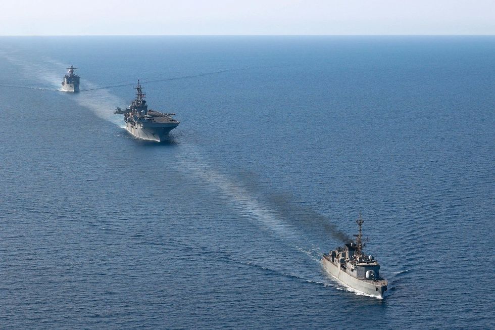 Handout photo dated August 8, 2023 shows the Royal Saudi Navy frigate 708 HMS Taif, the amphibious assault ship USS Bataan (LHD 5) and the dock landing ship USS Carter Hall (LSD 50) transit the Red Sea.