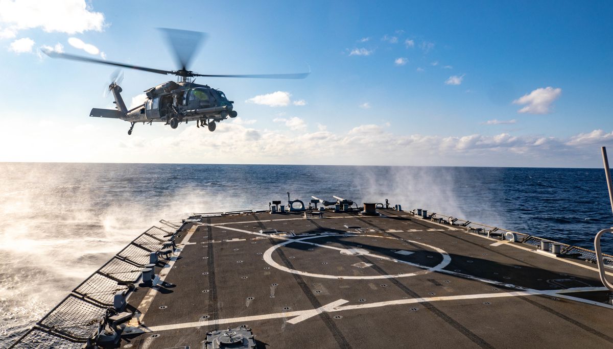 Handout photo dated January 26, 2023 shows Air Force 33rd Search and Rescue Squadron preparing to land aboard an Arleigh Burke-class guided-missile destroyer USS Benfold (DDG 65) in the Philippine Sea.