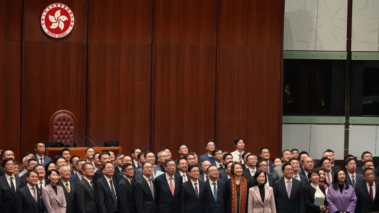 Hong Kong Chief Executive John Lee, government officials and lawmakers pose for a group photo, after the Safeguarding National Security Bill, also referred to as Basic Law Article 23, was passed at the Hong Kong’s Legislative Council, in Hong Kong, China March 19, 2024.
