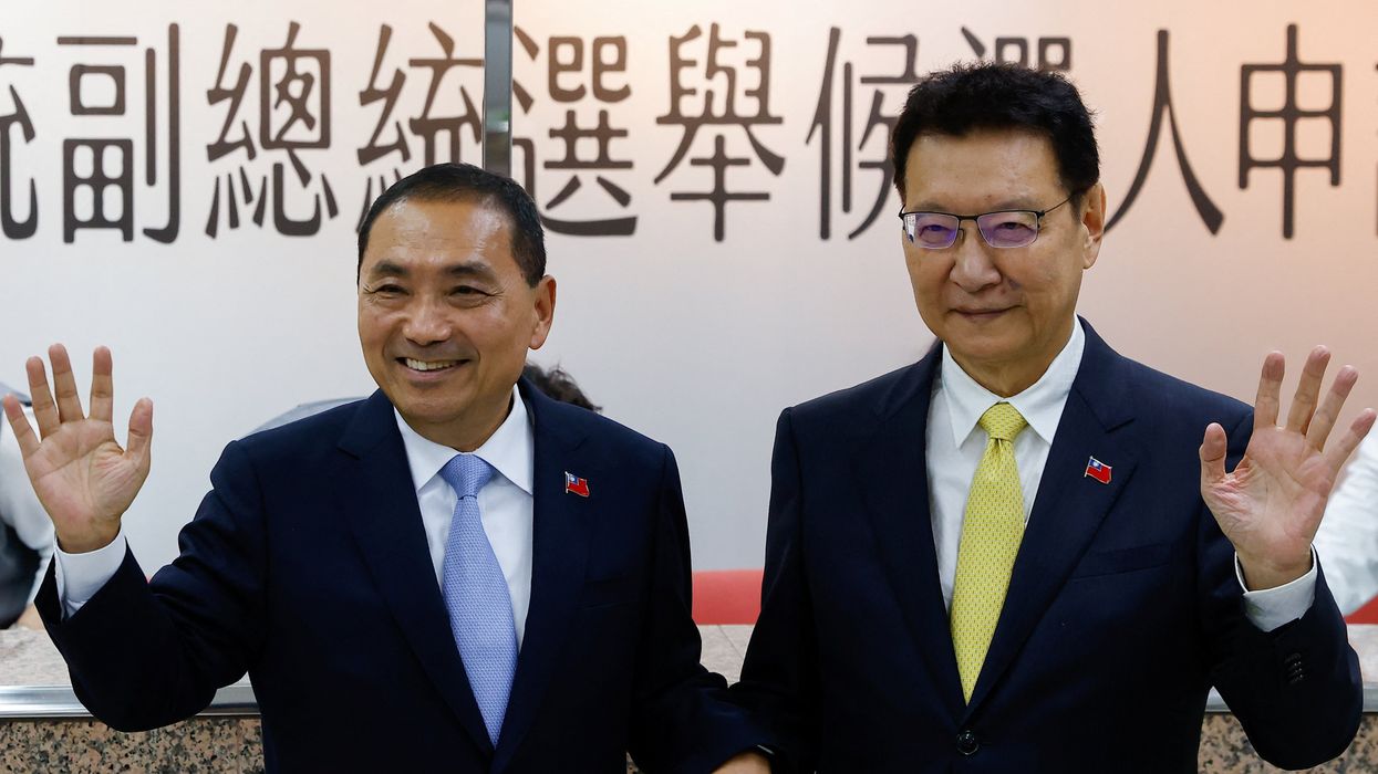 Hou Yu-ih, left, candidate for Taiwan's presidency from the main opposition Kuomintang Party, and Jaw Shaw-Kong, vice presidential candidate, wave at the Central Election Commission in Taipei on Nov. 24, 2023.