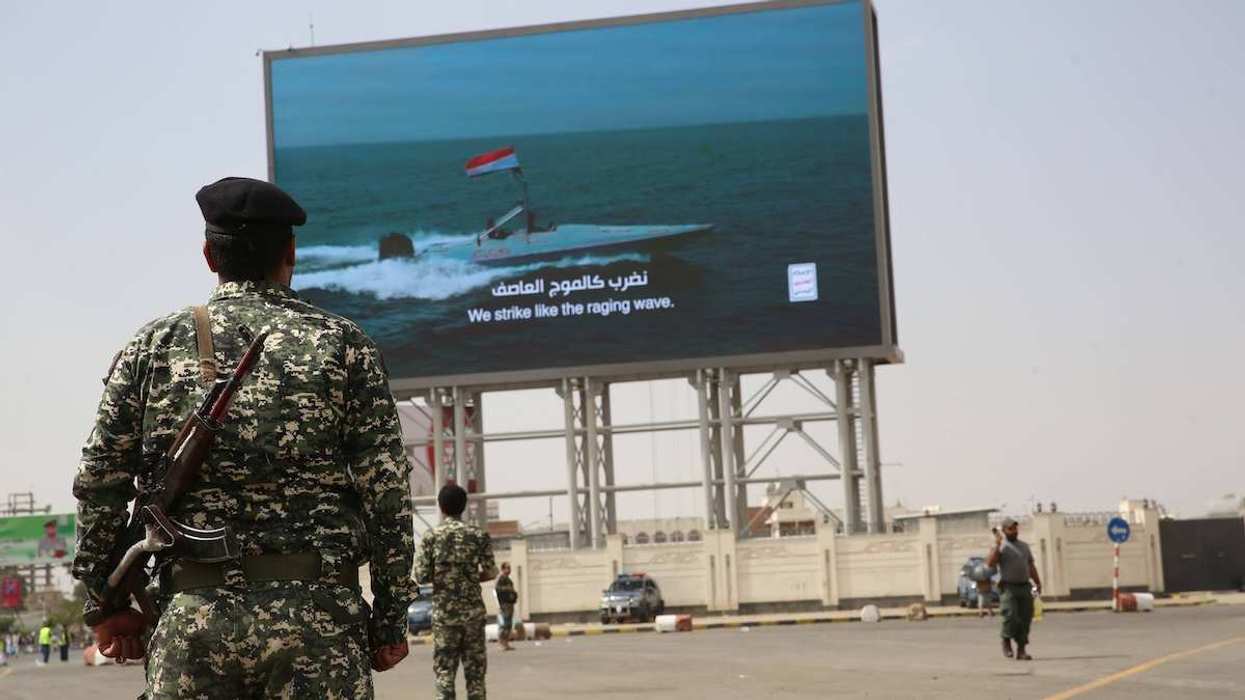 Houthi solders gather in front of a digital billboard in Sanaa, Yemen, on July 11, 2025.