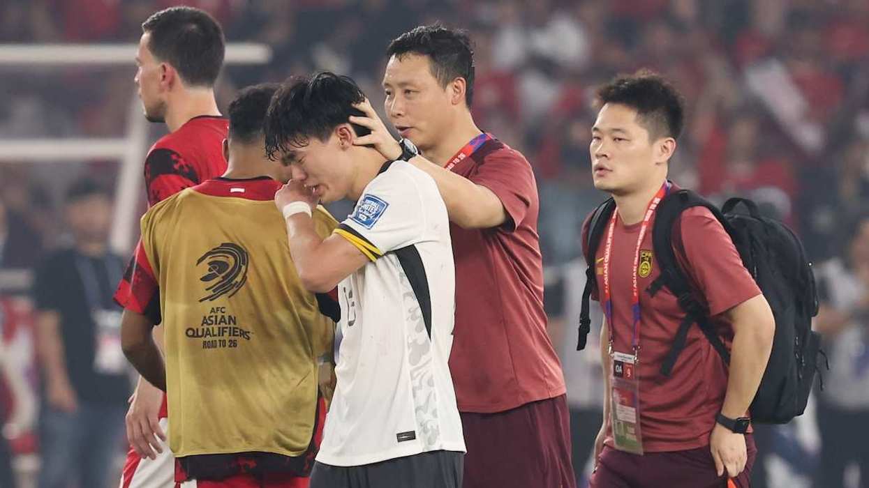 Hu Hetao #13 of China reacts after Indonesia defeated China 1-0 at Gelora Bung Karno Stadium in Jakarta, Indonesia, on June 5, 2025.