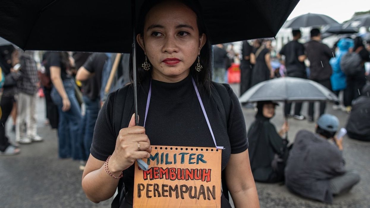 Human rights activists hold a placard reading 'Military is a Killer of Women' during Aksi Kamisan, or Thursday's Protest, in front of the Merdeka Palace in Jakarta, Indonesia, on March 20, 2025.