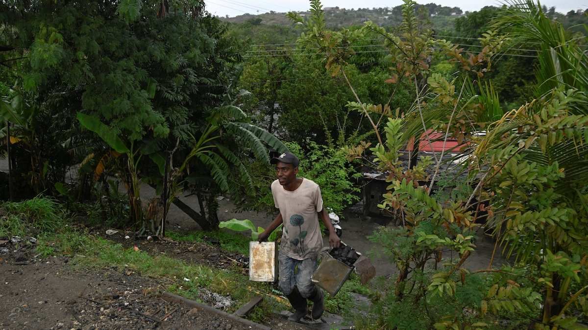 ​Igmel Tamayo carries charcoal to sell on the side of a road for use as cooking fuel in homes, on the outskirts of Havana, Cuba, on January 12, 2026.