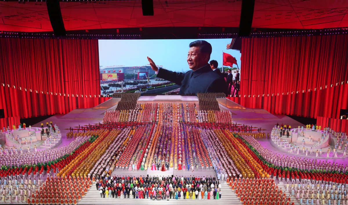 Image of Xi Jinping in the background of a performance during the 100th anniversary of China's Communist Party in Beijing.