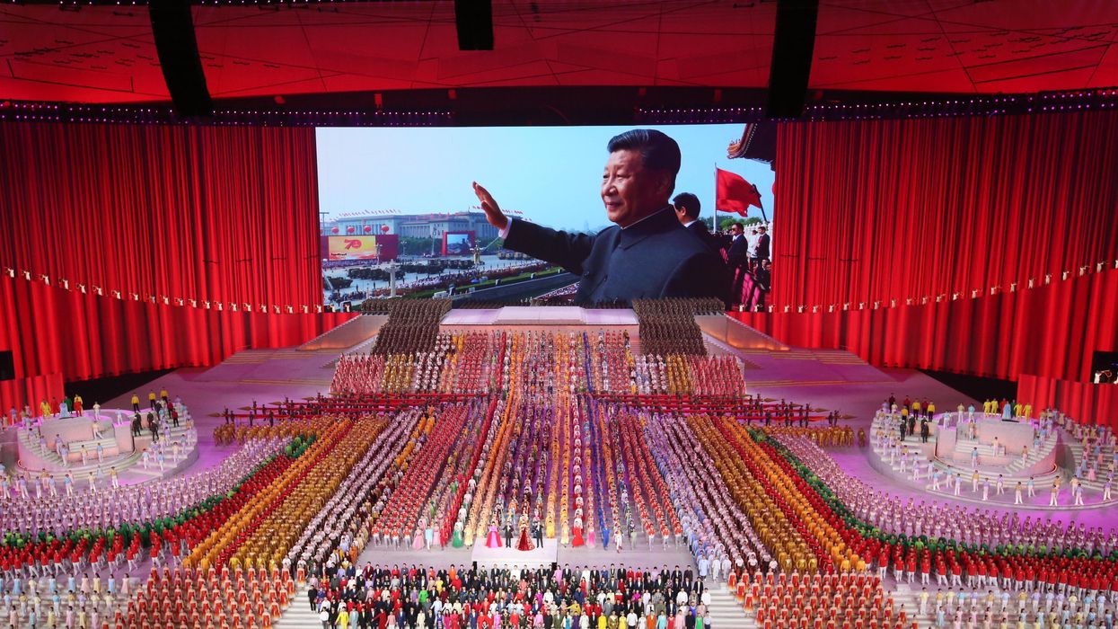 Image of Xi Jinping in the background of a performance during the 100th anniversary of China's Communist Party in Beijing.