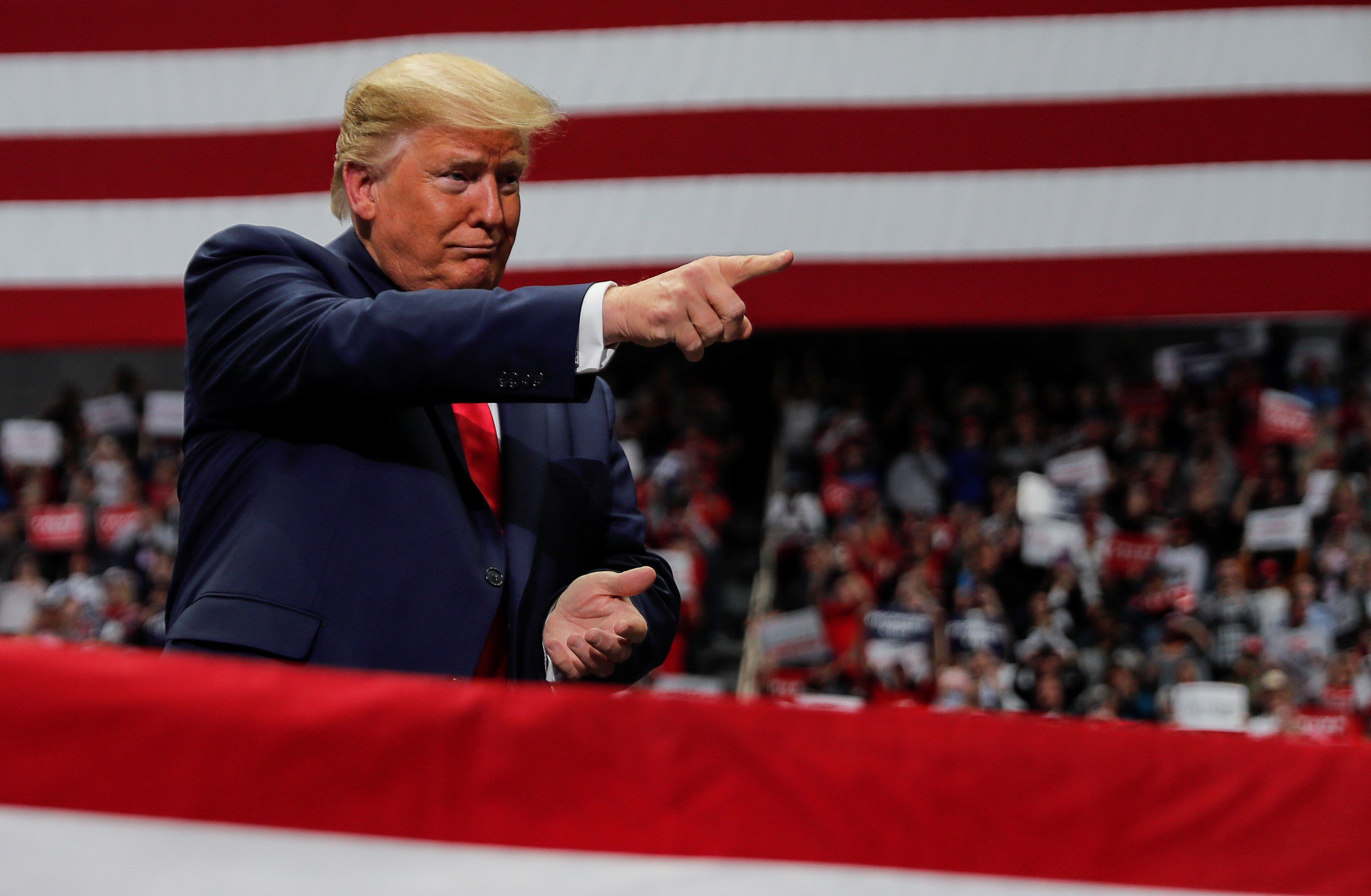 President Donald Trump pointing at a crowd 